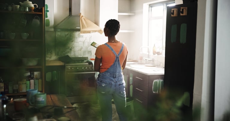 DIY, painting and thinking with black woman in kitchen of new house for maintenance from back. Paintbrush, real estate and restoration with homeowner person in apartment for development or renovation