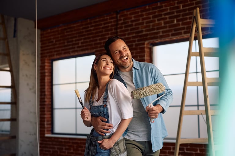 Happy homeowners having fun during home renovation process.